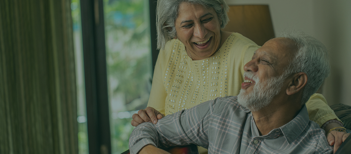 Older couple sitting together and smiling
