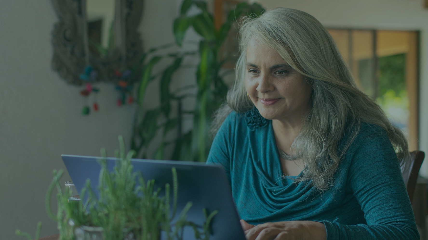 Smiling woman looking in her laptop